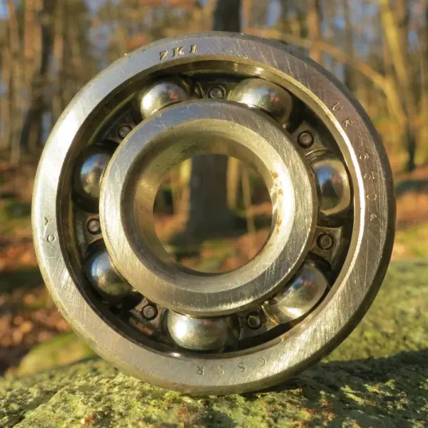 Used open 6304 deep groove ball bearing showing the balls and riveted steel cage